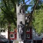 Mutter Kinzig monument with a stone eagle atop a tall shaft and a dark female figure below.