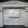 Titanic Musicians\' Memorial plaque set in a red brick archway with carved inscriptions and a relief of a musician playing an instrument.