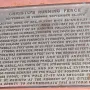 Bronze commemorative plaque for Running Fence mounted on a reddish-brown wall.