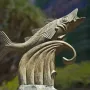 The Chicharro Sculpture shows a metallic fish leaping from a stylized wave outdoors.