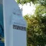Garibaldi Monument with a bearded bust and floral tribute at the base