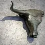 Toros de Costitx bronze bull head with a green patina mounted on a stone wall