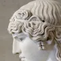 Left-side profile of the Antinous Mondragone marble head with wavy hair and a calm expression.