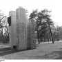 Julius Fučík Memorial with tall steles, a dark profile bust, and an inscribed panel in a park setting.