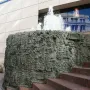 San Francisco Fountain with water spraying from a dark metallic sculptural structure beside brick steps.