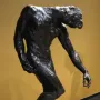 The Three Shades bronze sculpture by Auguste Rodin, showing a bowed figure on a rocky base.