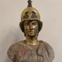 Bust of Athena Giustiniani with a gilded female head and helmet above a mottled marble torso with drapery and a Medusa head.