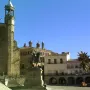 Francisco Pizarro equestrian statue on a stone pedestal in a sunlit square.