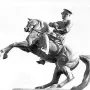Statue of Honor, an equestrian sculpture of a man in military uniform holding a sword on a rearing horse.
