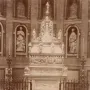 Arca di San Domenico inside a vaulted chapel, with a towering carved funerary monument, railings, and candelabras