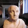 Double herm of Socrates and Seneca, showing the inscribed bust of Seneca in a museum gallery.