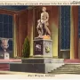 Abraham Lincoln: The Hoosier Youth bronze statue of a seated young Lincoln holding a book, with an axe and a dog beside him.