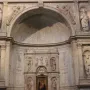 White marble statue of Saint Gregory in a carved alcove, holding an open book and wearing a miter.
