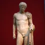 Hermes of Aegium marble statue of a nude male figure with drapery over one shoulder and a tree trunk support