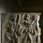 Roman marble relief from the Sarcophagus of the Triumph of Bacchus showing a bearded satyr-like figure playing panpipes beside a dancing woman with a tambourine and a serpent emerging from a vessel.