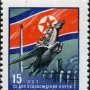 Postage stamp depicting the Chollima Statue with a winged horse carrying a worker and farmer, with industrial imagery and Cyrillic text.